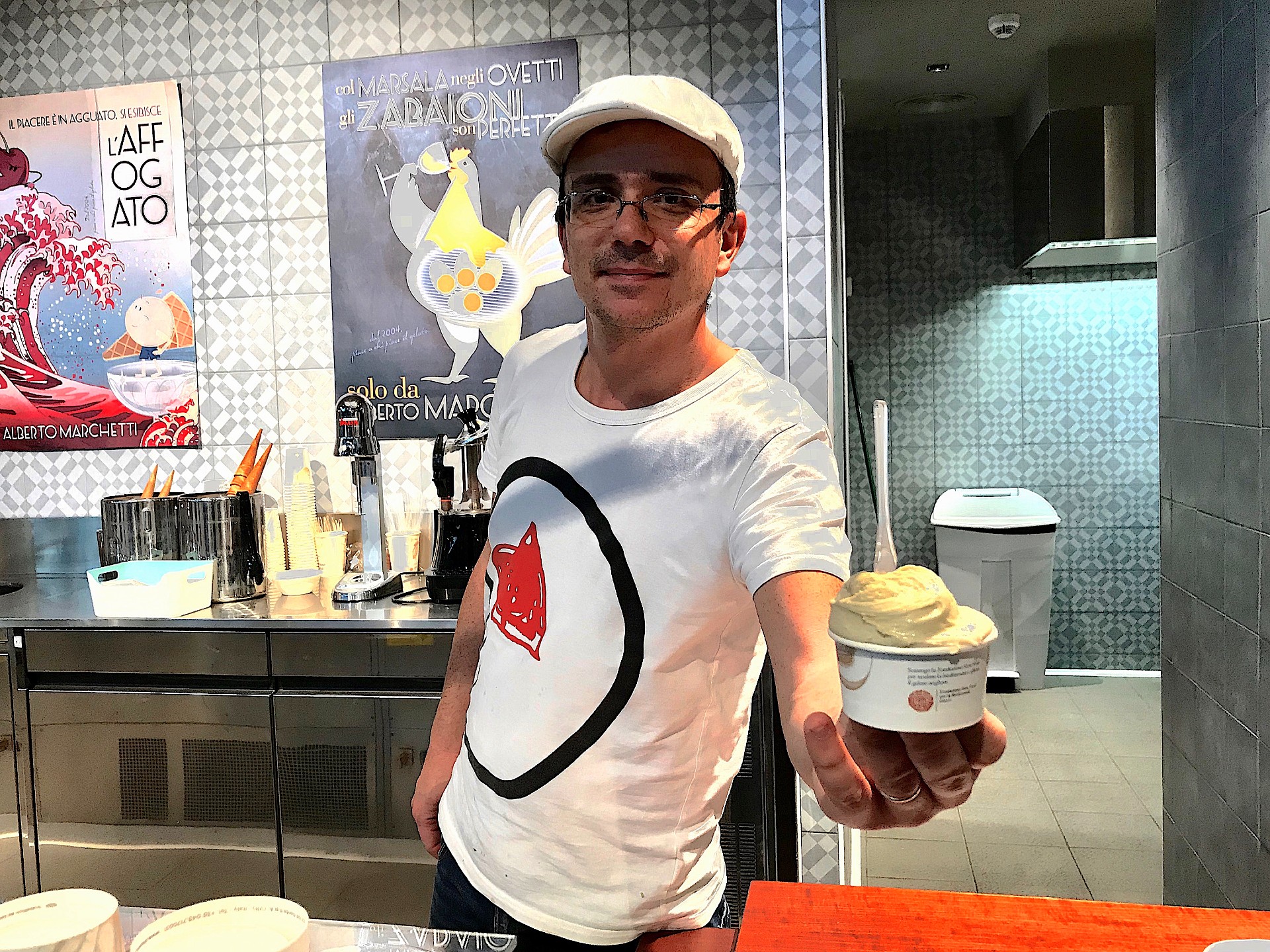 Italian man serving a cup of gelato