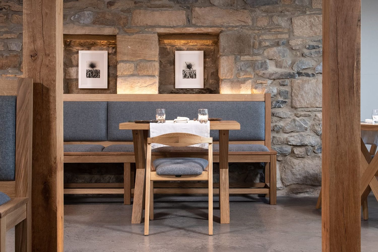 Wooden furniture and grey padded seating make up the trendy seating for diners. Out of shot, there are wooden framed windows where guests can admire views over the Yorkshire Dales.