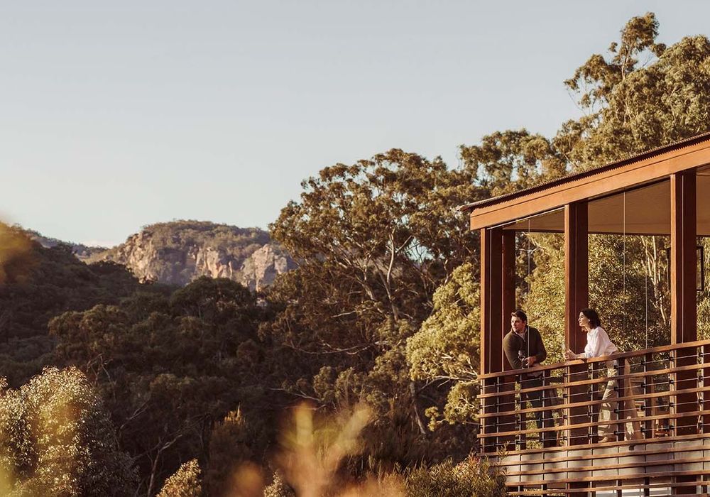 A couple stood on a balcony overlooking the Blue Mountains scenery.