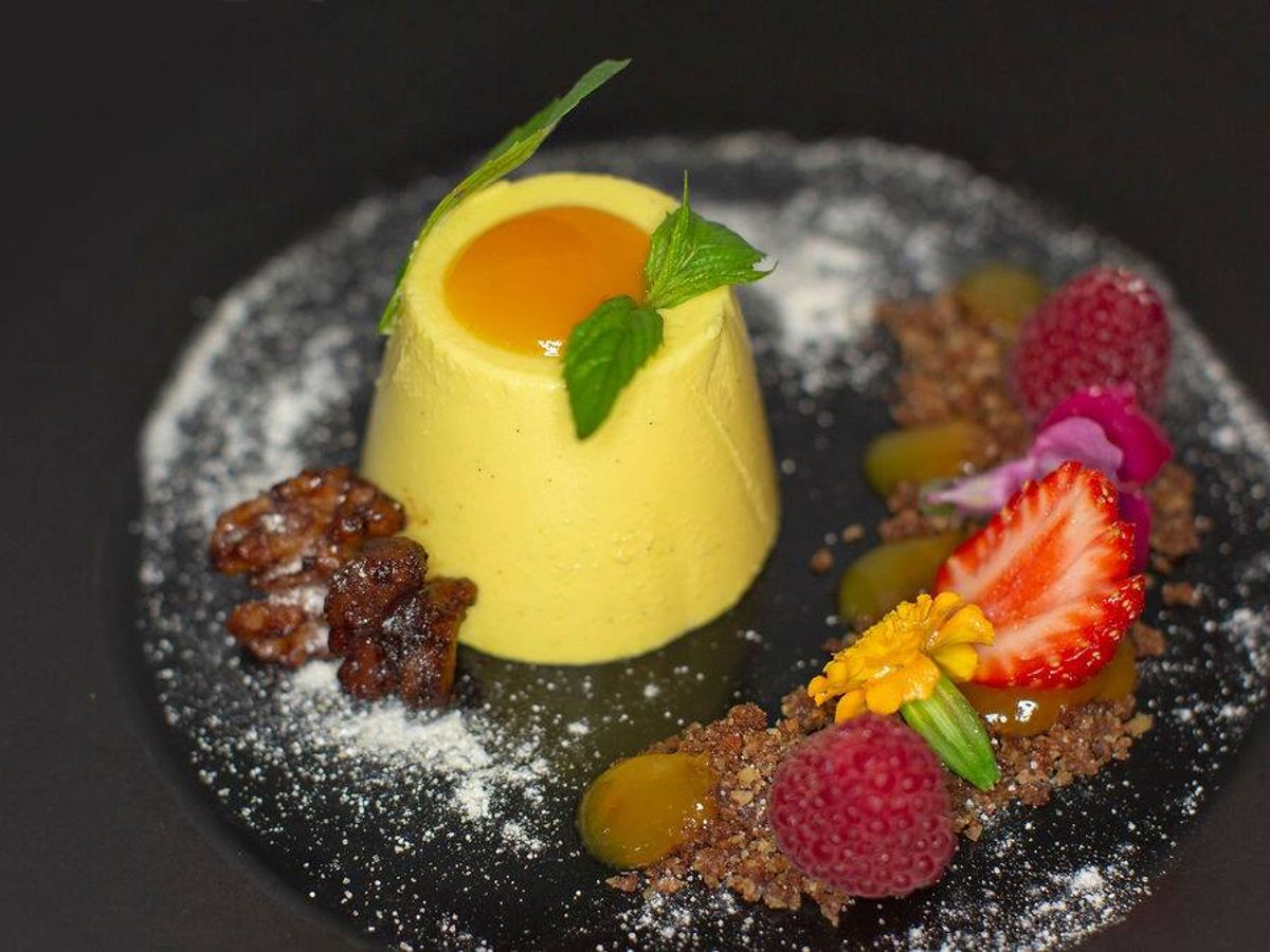 A meticulously prepared dessert sits on a black plate, served at the Pins Lurline restaurant in the Blue Mountains.