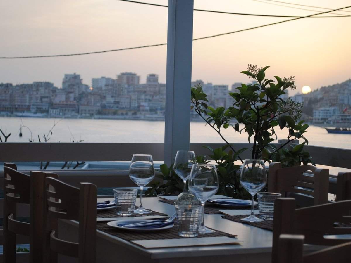 A dining table overlooking sunset at the Albanian Riviera. 