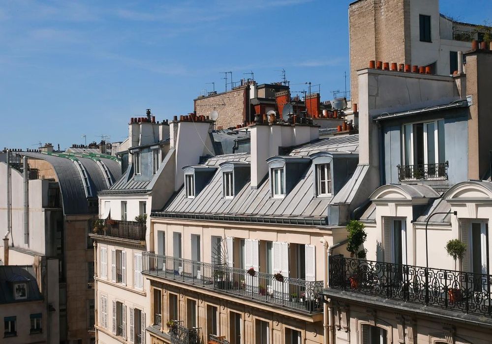 Maison Mere is situated on an aesthetic Parisian street in the 9th arrondissement. This image shows the upper street view with a series of balconies.